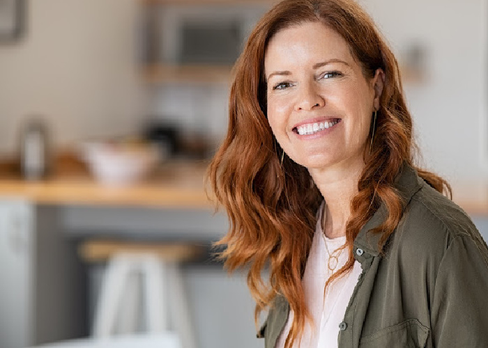woman with long red hair smiling