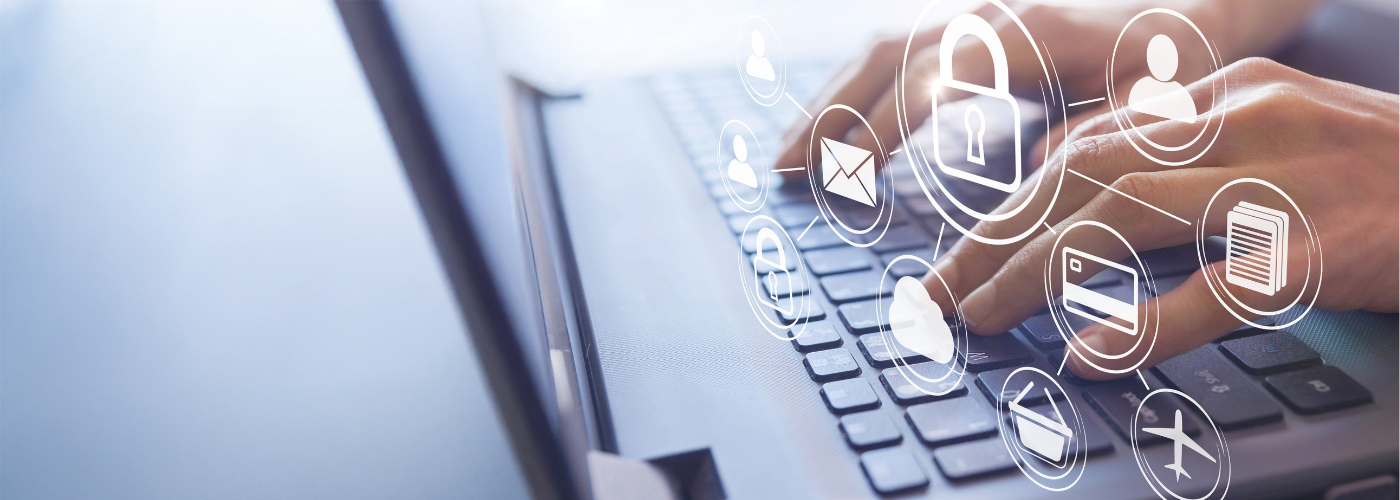 Person typing on laptop with multiple floating icons above keyboard