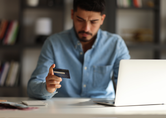 man-looking-at-credit-card-identity-theft