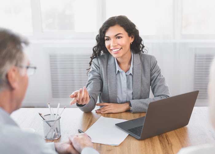 Woman reviewing financial documents with advisor.