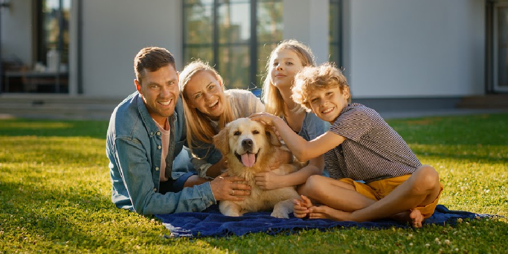 Family on grass with dog