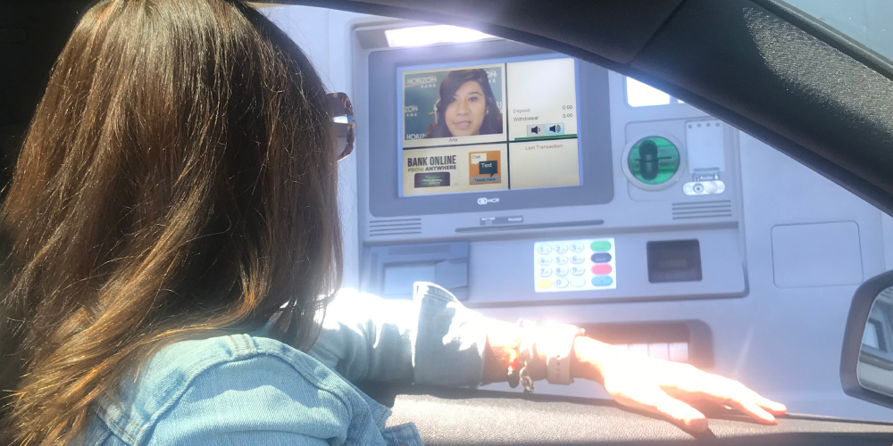 Woman at video banking machine