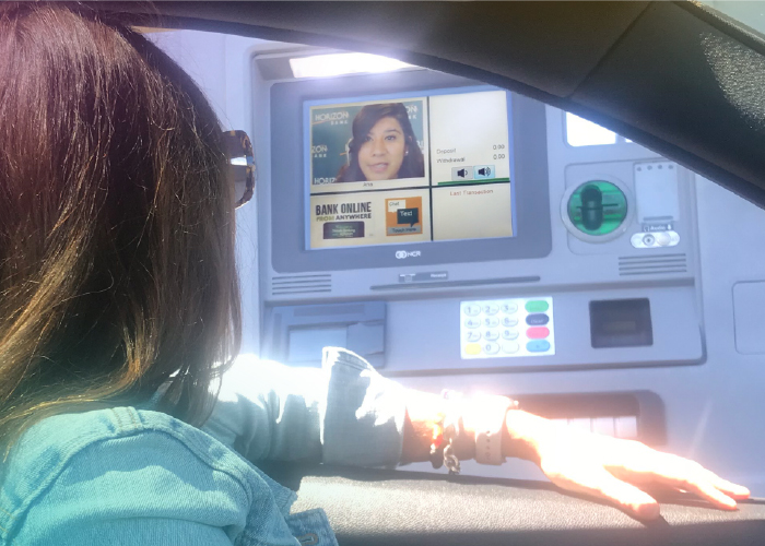 girl in car sitting at the Live Video Banking driveup