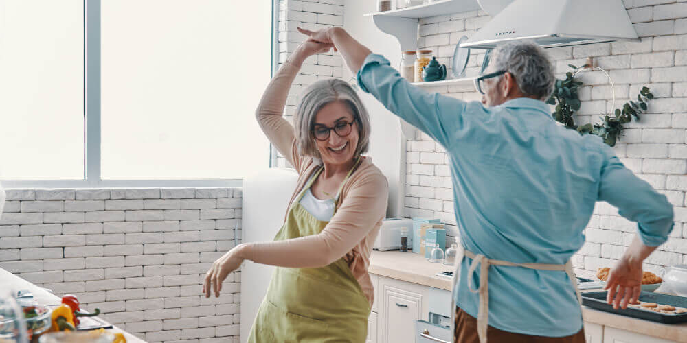 Older couple in a kitchen dancing