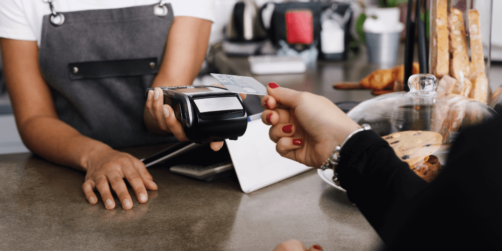 Person giving credit card to employee