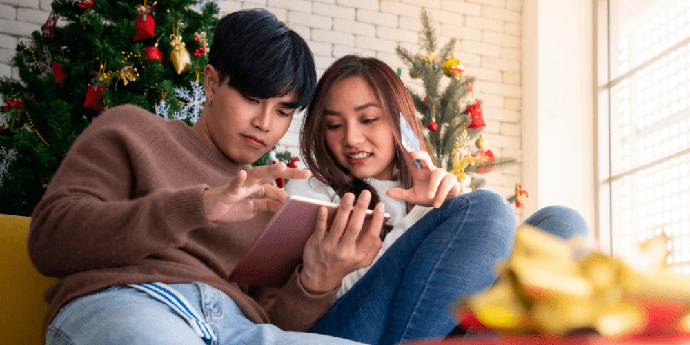 Couple on couch holiday shopping