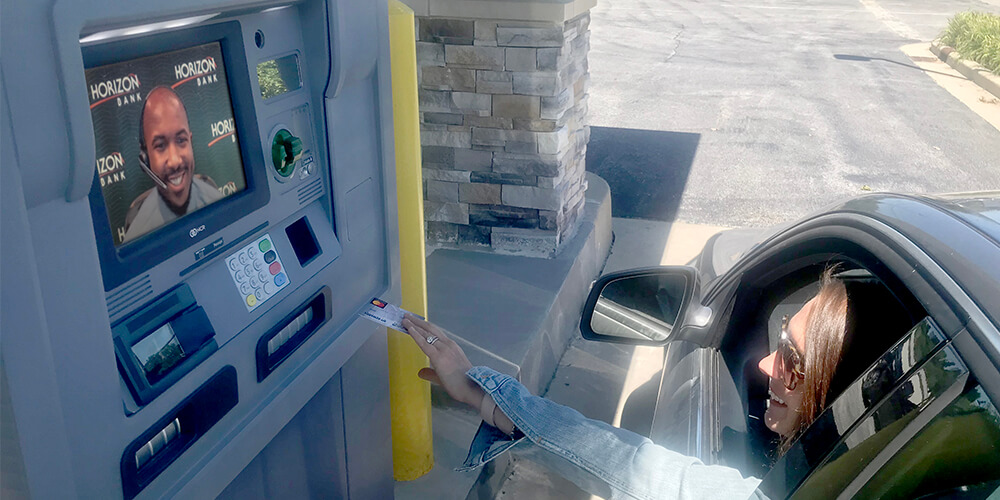Woman in car next to ATM