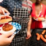 burger and hot dogs on a grill