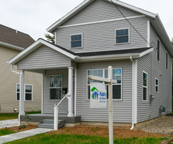 Grey house with Habitat for Humanity sign 