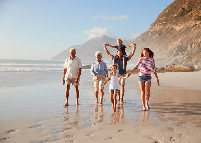 Multi generational family walking on the beach